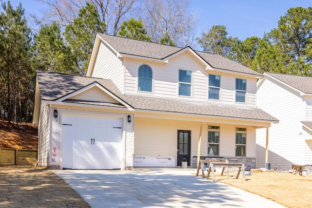 traditional home with a garage, driveway, a shingled roof, and a porch