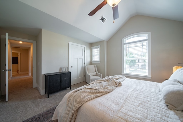 bedroom with carpet flooring, ceiling fan, vaulted ceiling, and multiple windows