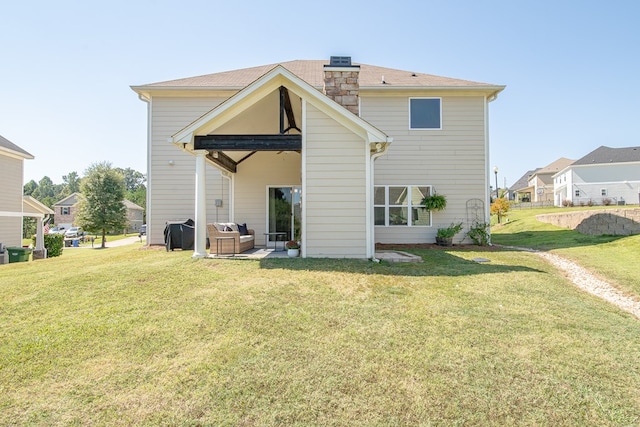 rear view of house featuring a patio area, a yard, and an outdoor hangout area