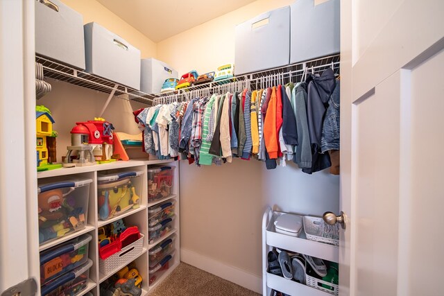 walk in closet with carpet floors