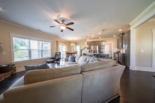 living room with dark hardwood / wood-style flooring, ceiling fan, and ornamental molding