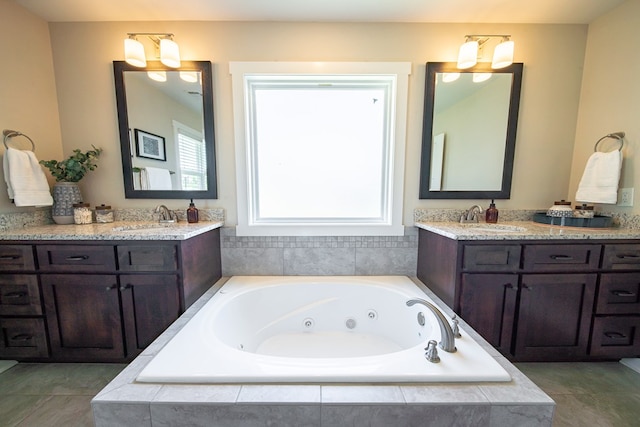 bathroom featuring vanity, tiled bath, and an inviting chandelier