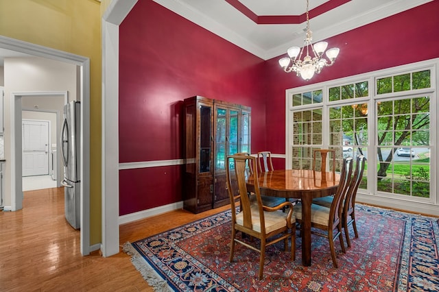 5043 Spyglass Ct, Columbus, GA 31909 - dining room with a chandelier, crown molding, baseboards, wood finished floors, and a high ceiling