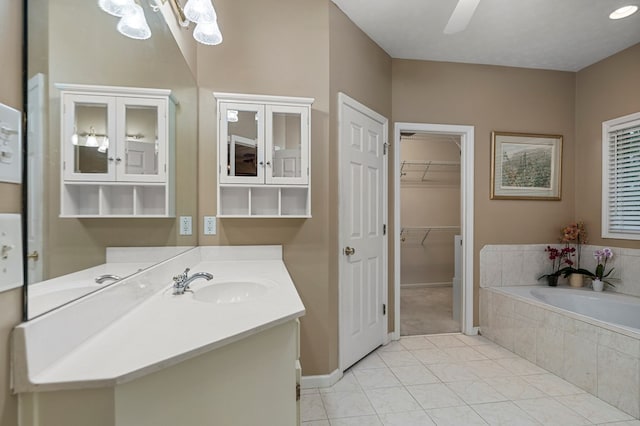 5043 Spyglass Ct, Columbus, GA 31909 - bathroom with a bath, vanity, tile patterned flooring, a walk in closet, and a ceiling fan