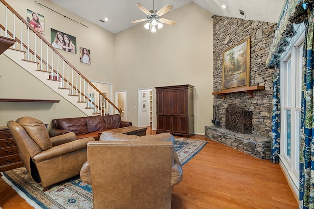 5043 Spyglass Ct, Columbus, GA 31909 - living area with stairs, high vaulted ceiling, a ceiling fan, wood finished floors, and a stone fireplace