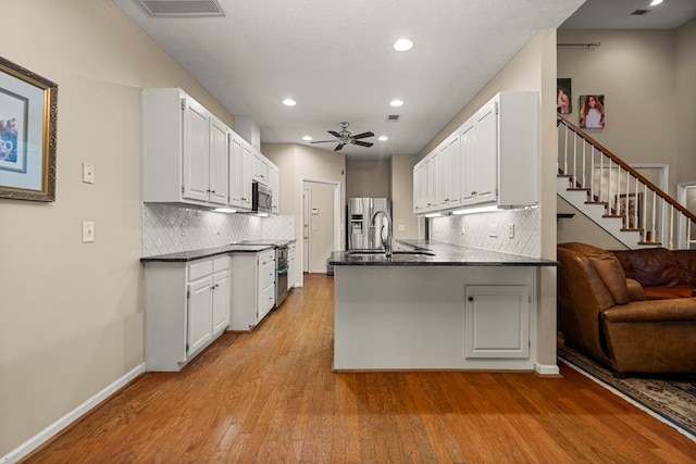 5043 Spyglass Ct, Columbus, GA 31909 - kitchen with appliances with stainless steel finishes, light wood-type flooring, a peninsula, a ceiling fan, and recessed lighting