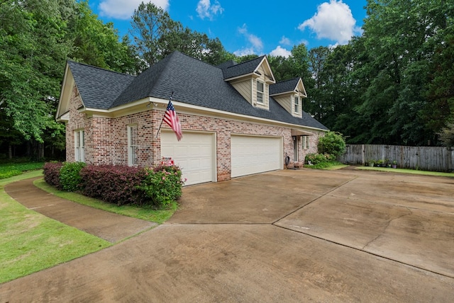 5043 Spyglass Ct, Columbus, GA 31909 - view of side of home featuring brick siding, a garage, roof with shingles, and driveway
