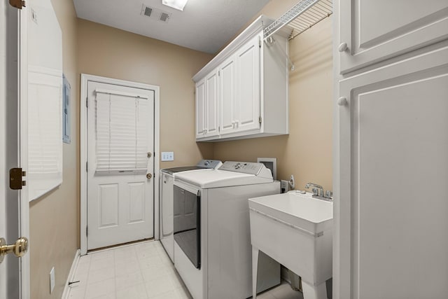 5043 Spyglass Ct, Columbus, GA 31909 - laundry room featuring separate washer and dryer, cabinet space, baseboards, and light floors