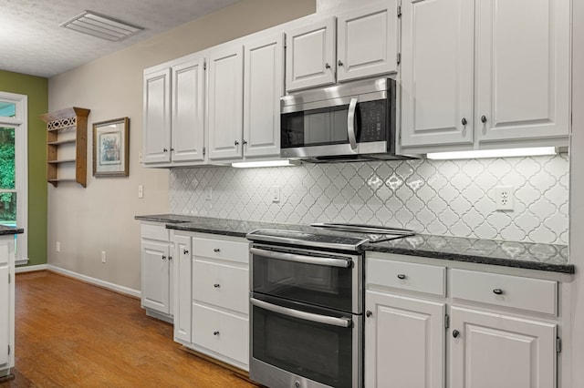 5043 Spyglass Ct, Columbus, GA 31909 - kitchen featuring appliances with stainless steel finishes, backsplash, and white cabinets