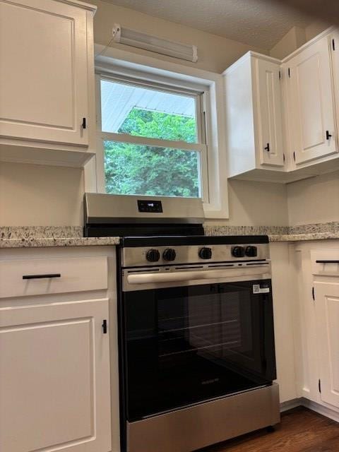 5435 Mariner Dr, Columbus, GA 31909 - kitchen featuring stainless steel range with electric stovetop, white cabinetry, light stone counters, and dark wood-type flooring