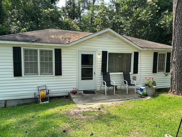 2821 Barbara Rd, Columbus, GA 31907 - back of property featuring a shingled roof, a lawn, and a patio