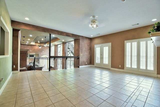 tiled spare room with baseboards, visible vents, a ceiling fan, french doors, and recessed lighting