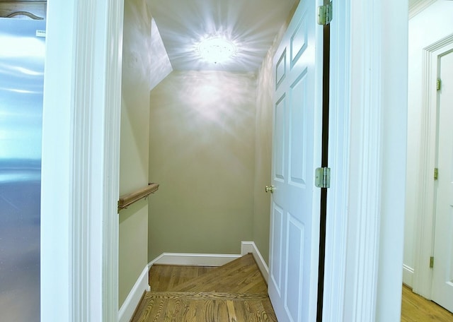 hall featuring wood finished floors and baseboards