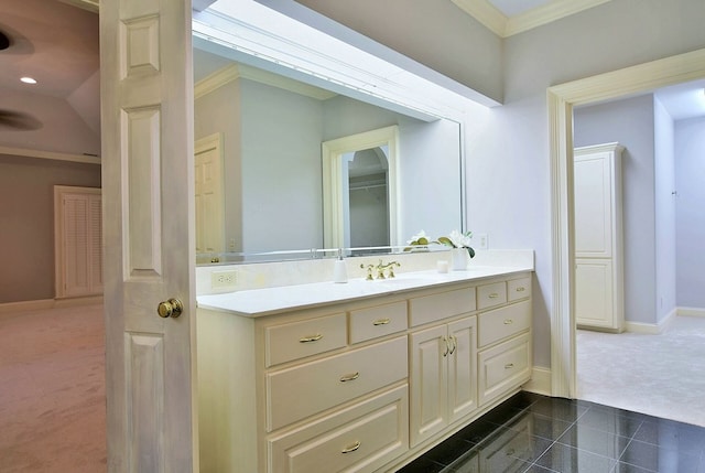 bathroom with ornamental molding, tile patterned floors, vanity, and baseboards