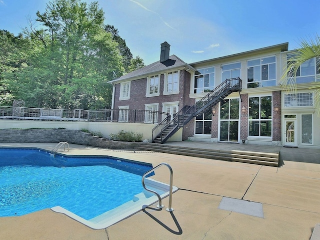 view of swimming pool with stairs, a patio area, and a fenced in pool