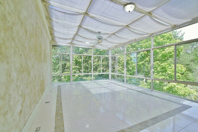 unfurnished sunroom with a ceiling fan