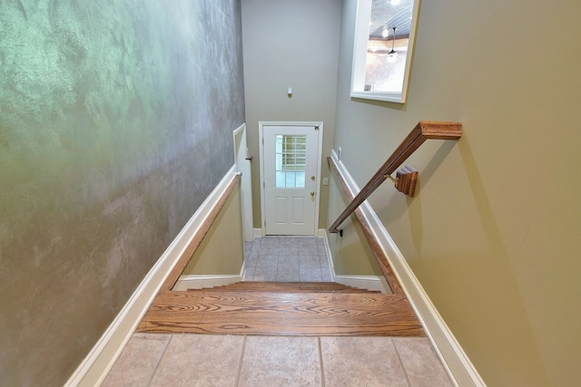 stairway featuring baseboards