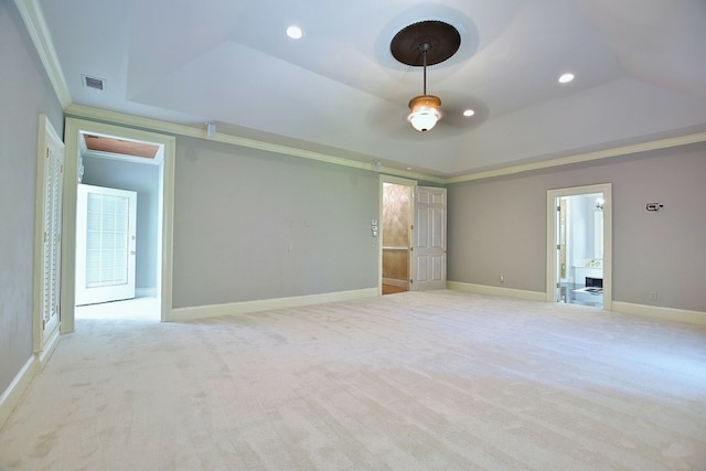 carpeted spare room featuring recessed lighting, visible vents, baseboards, ornamental molding, and a tray ceiling