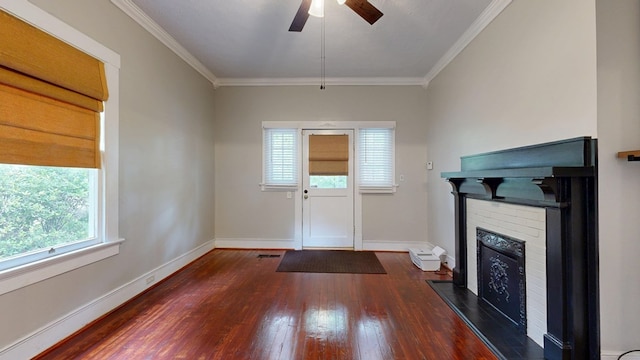 unfurnished living room with hardwood / wood-style flooring, a fireplace, baseboards, ornamental molding, and ceiling fan