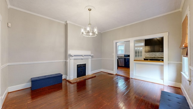 unfurnished living room with wood finished floors, a fireplace with raised hearth, a chandelier, crown molding, and baseboards
