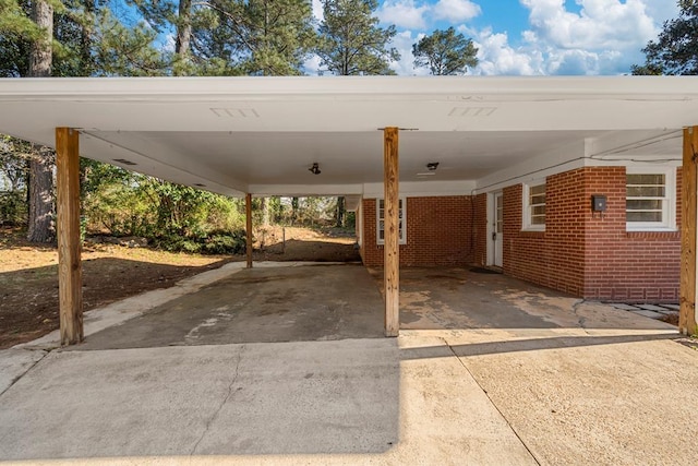 view of car parking with an attached carport and driveway