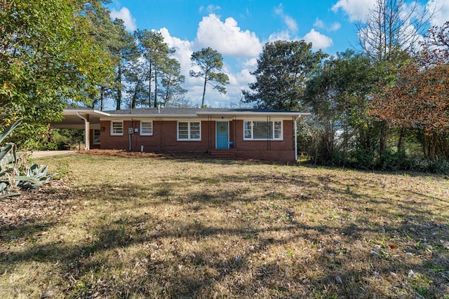 ranch-style home with an attached carport, brick siding, and a front lawn