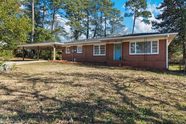 single story home featuring a carport, brick siding, driveway, and a front lawn