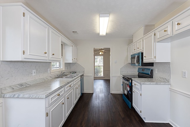 kitchen with black appliances, white cabinets, sink, ceiling fan, and a textured ceiling