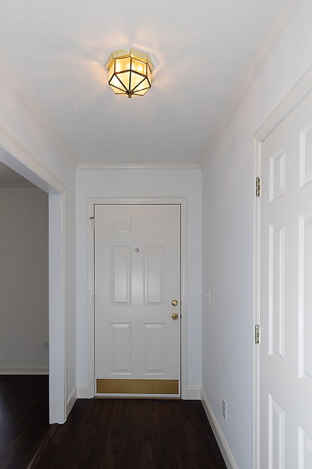 doorway to outside with dark hardwood / wood-style floors and ornamental molding