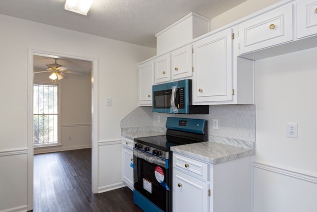 kitchen featuring black electric range oven, white cabinets, ceiling fan, tasteful backsplash, and light stone counters