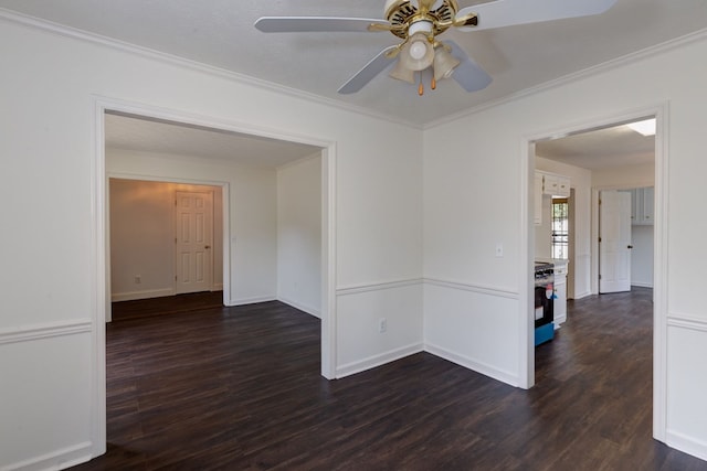 spare room with ceiling fan, dark hardwood / wood-style flooring, and crown molding