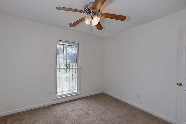 spare room featuring carpet and ceiling fan