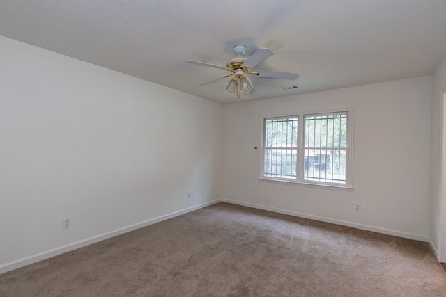 unfurnished room with ceiling fan and light colored carpet