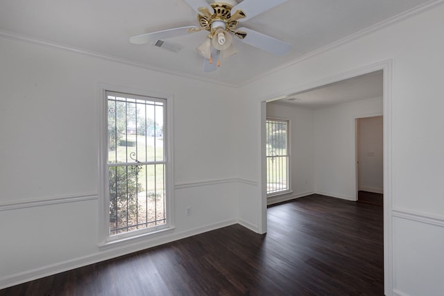 spare room with dark hardwood / wood-style flooring, ceiling fan, and crown molding