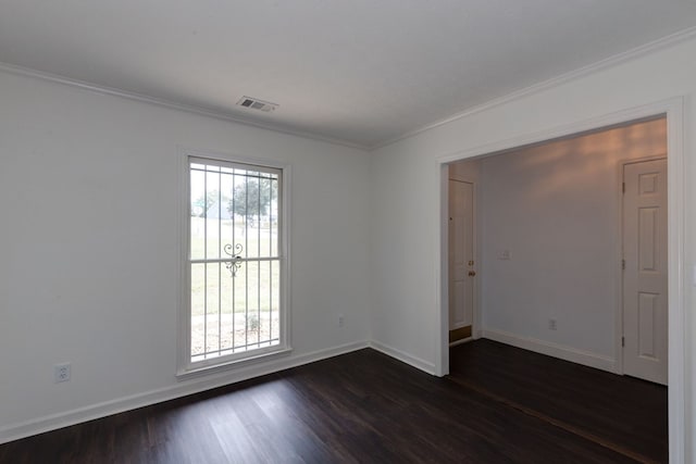 unfurnished room with ornamental molding and dark wood-type flooring