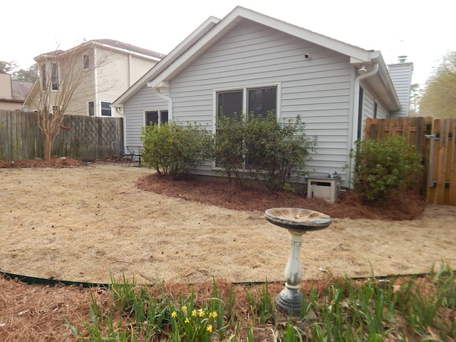 rear view of house featuring fence