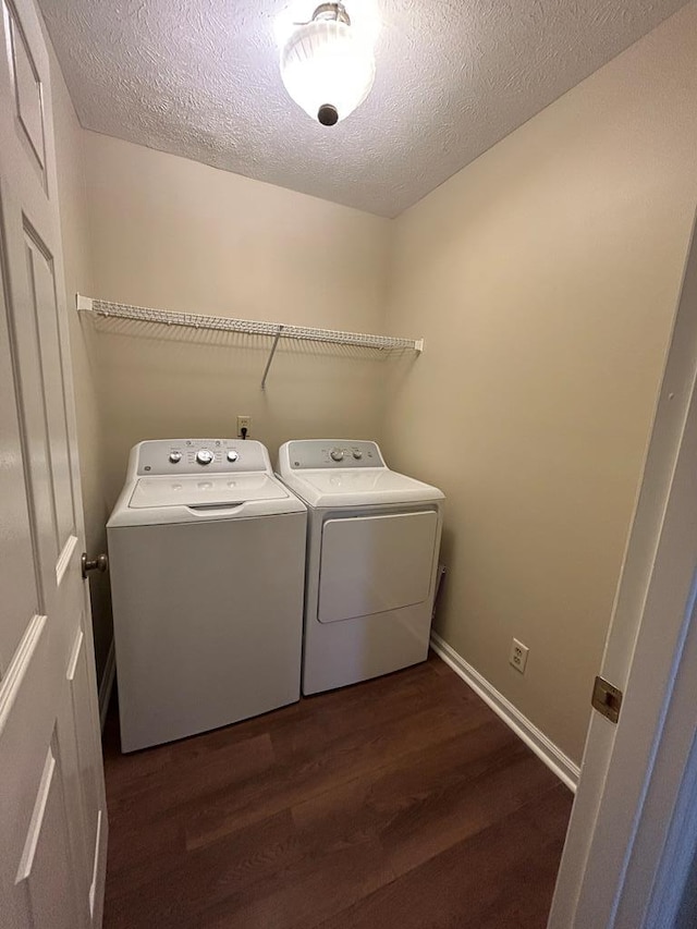 washroom featuring laundry area, a textured ceiling, dark wood-style flooring, and independent washer and dryer