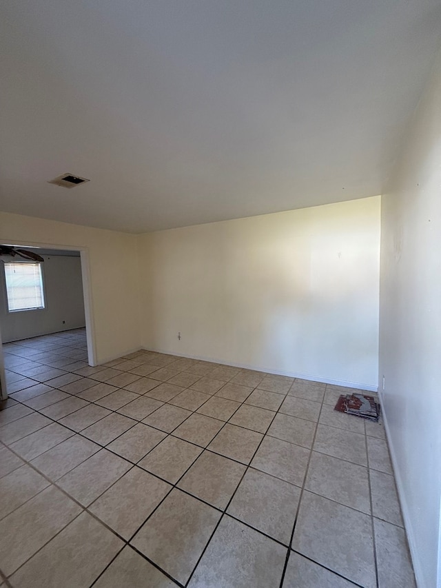 unfurnished room with light tile patterned floors and visible vents