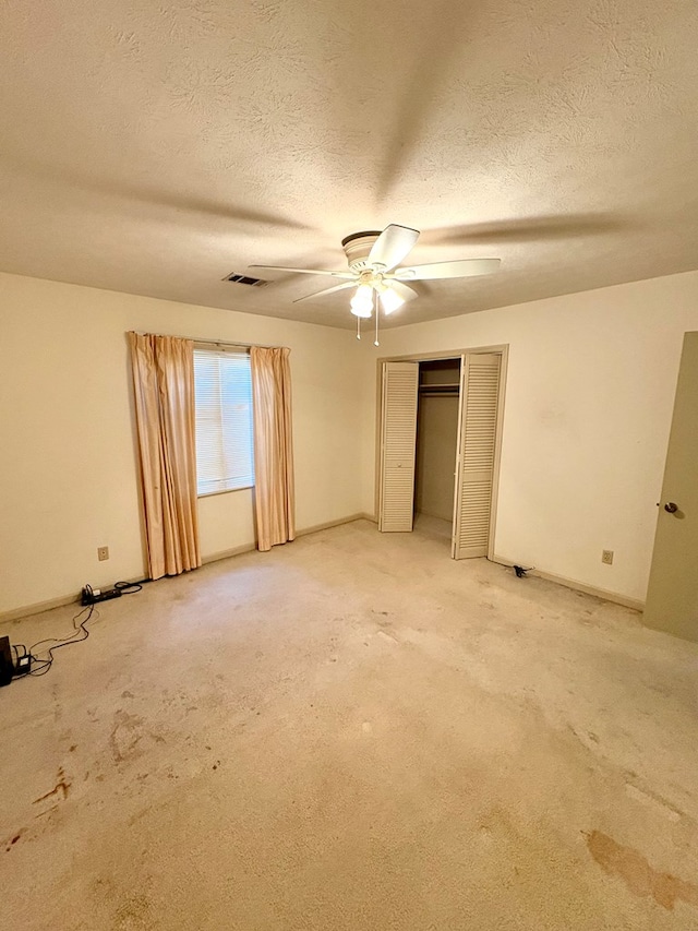 5302 Pine Needle Dr, Columbus, GA 31907 - unfurnished bedroom featuring a textured ceiling, ceiling fan, light carpet, and a closet