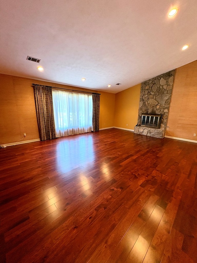 5302 Pine Needle Dr, Columbus, GA 31907 - unfurnished living room featuring hardwood / wood-style flooring and a stone fireplace