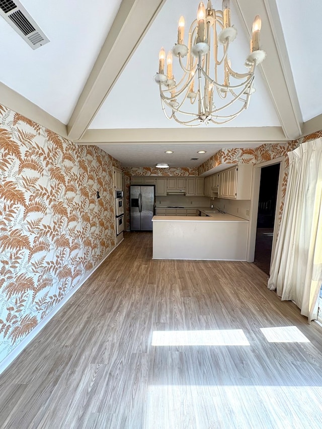 5302 Pine Needle Dr, Columbus, GA 31907 - unfurnished living room with wallpapered walls, light wood-style flooring, and a chandelier