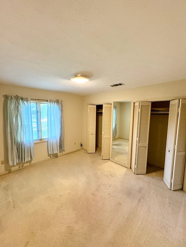 5302 Pine Needle Dr, Columbus, GA 31907 - unfurnished bedroom with multiple closets and carpet flooring