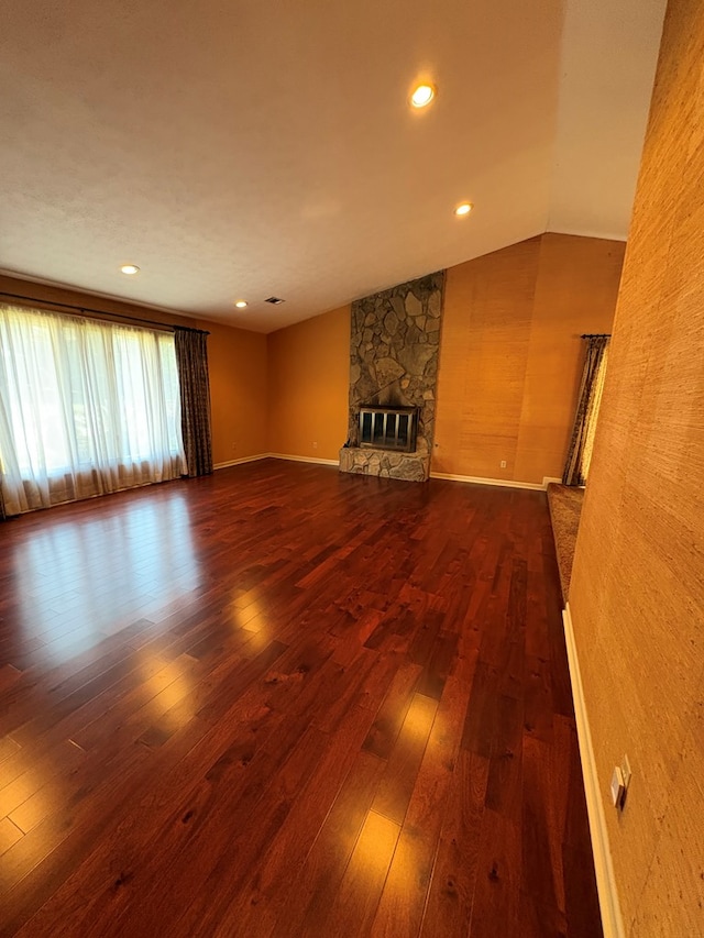 5302 Pine Needle Dr, Columbus, GA 31907 - unfurnished living room featuring dark wood-type flooring, a stone fireplace, vaulted ceiling, and recessed lighting