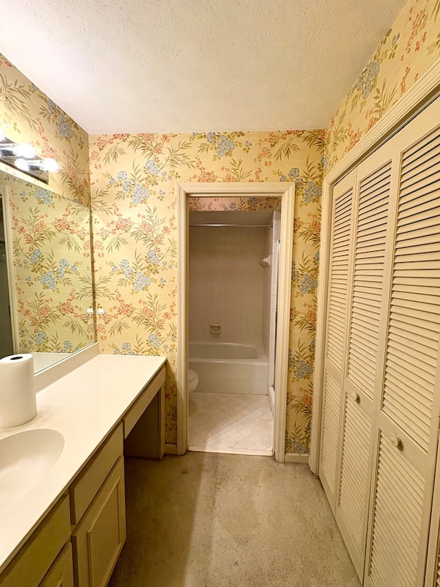5302 Pine Needle Dr, Columbus, GA 31907 - bathroom with a closet, vanity, wallpapered walls, and a textured ceiling