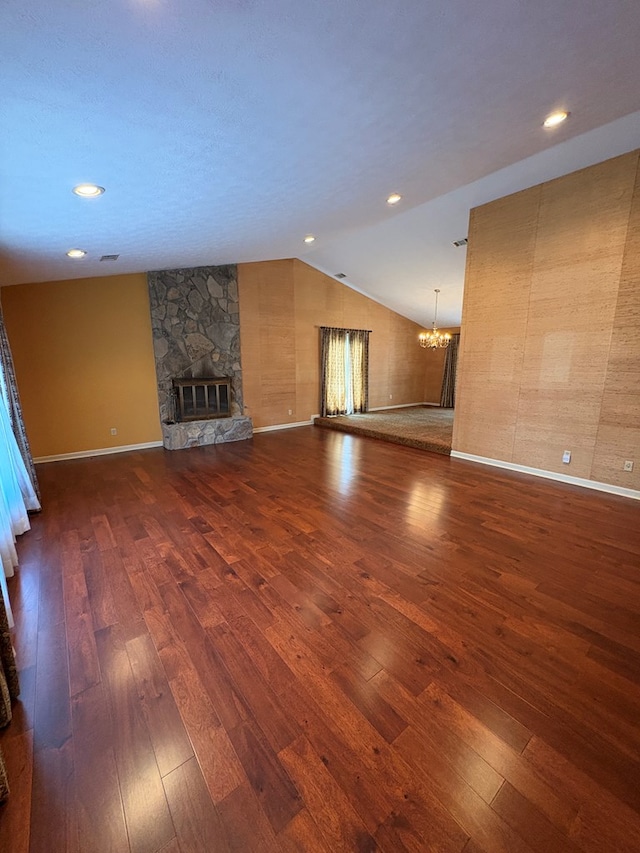 5302 Pine Needle Dr, Columbus, GA 31907 - unfurnished living room with dark wood-style floors, a chandelier, a fireplace, vaulted ceiling, and recessed lighting