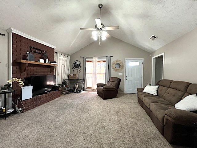 carpeted living room with ceiling fan, lofted ceiling, a textured ceiling, and a brick fireplace