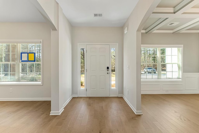 entryway with light hardwood / wood-style floors, beamed ceiling, and coffered ceiling