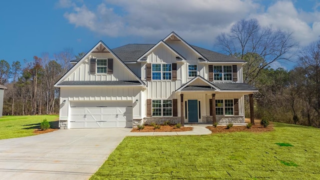 view of front of house featuring a front yard, a garage, and a porch