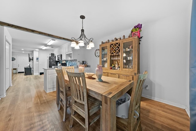 5608 Grove Ave, Columbus, GA 31904 - dining space with light wood-style floors and a chandelier