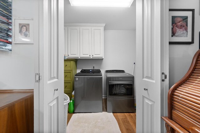 5608 Grove Ave, Columbus, GA 31904 - laundry room with cabinet space, independent washer and dryer, and light wood-style floors